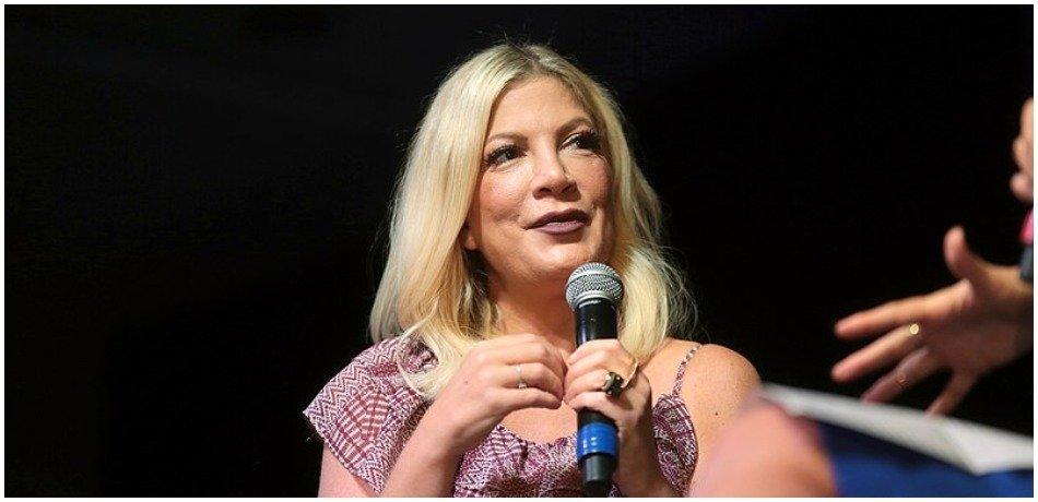 Tori Spelling speaks at an event.