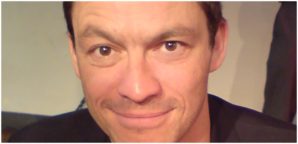 Actor Dominic West smiles for the camera.