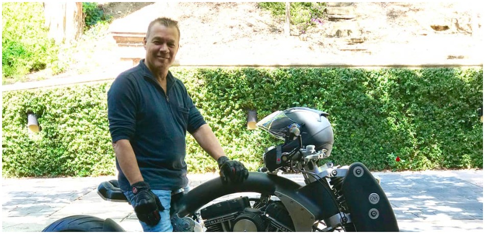 Eddie Van Halen poses with his motorcycle.