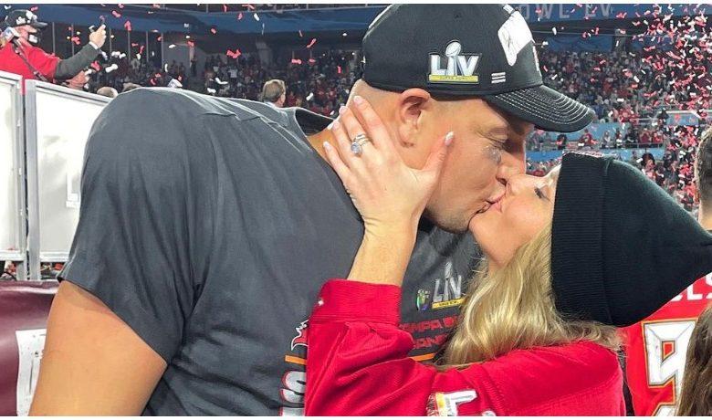 Rob Gronkowski and girlfriend Camille Kostek kiss at the Super Bowl.