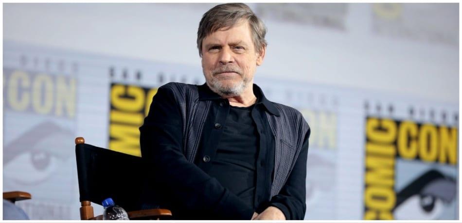 Mark Hamill sitting in a chair