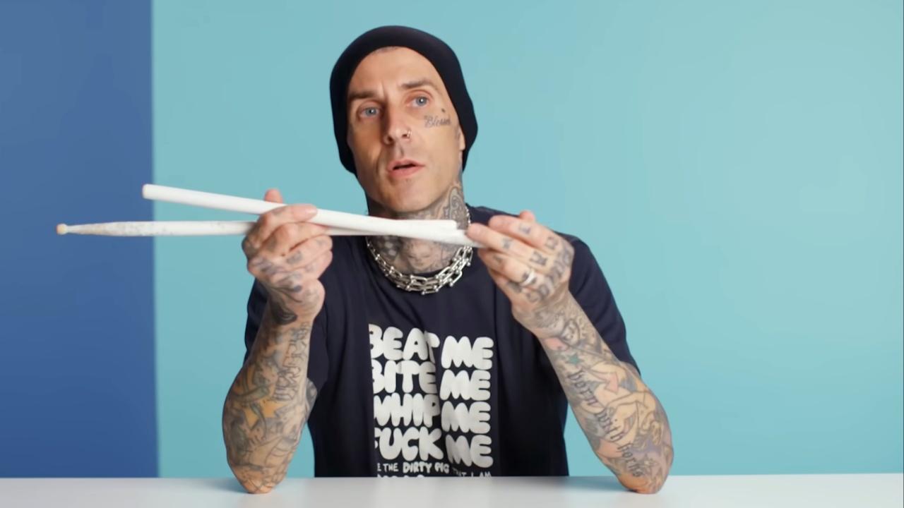 travis barker with drumsticks