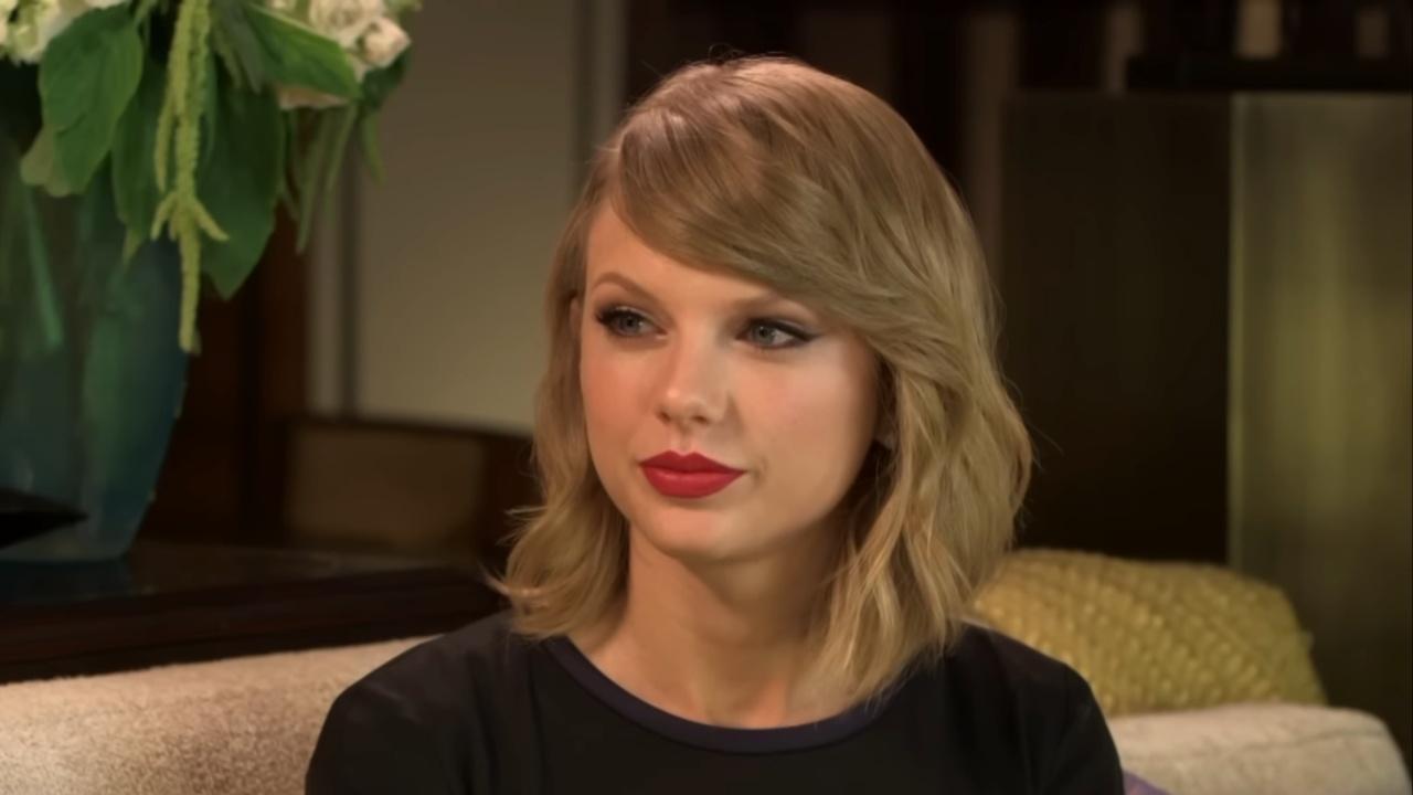 Taylor Swift wearing red lipstick.