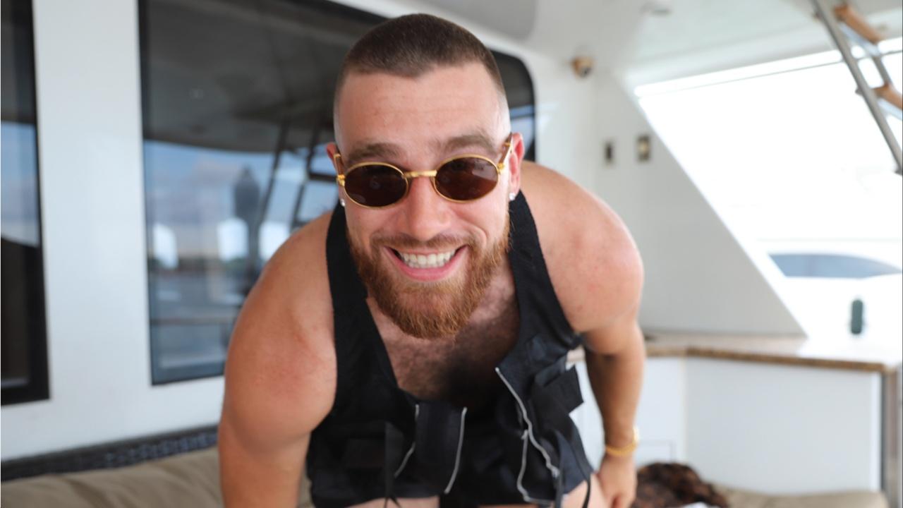 Travis Kelce smiling on a boat.